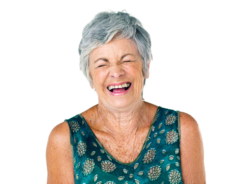 Studio shot of an elderly woman laughing against a white background