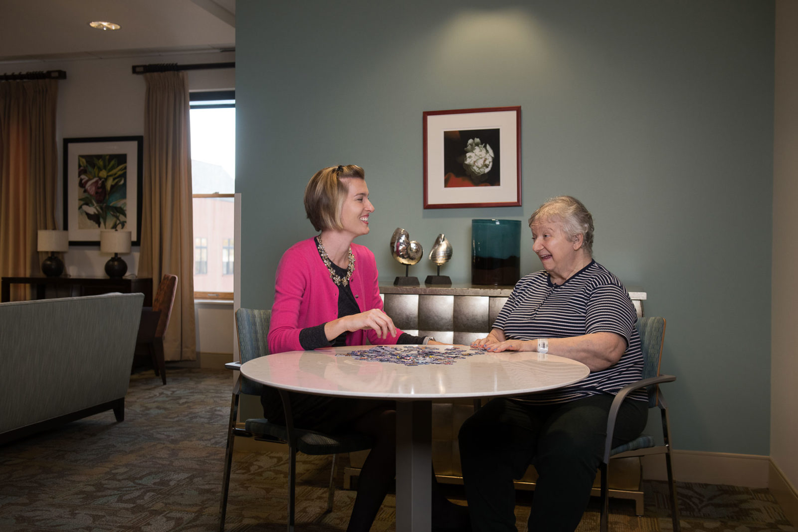 caregiver playing cards with elderly woman