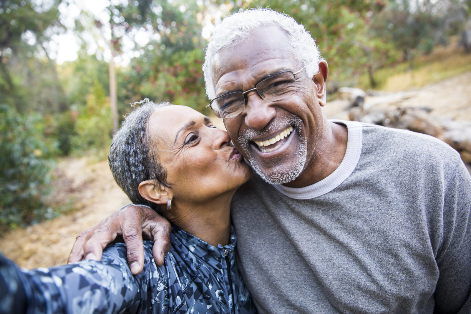 elderly couple pausing after workout on outdoor path