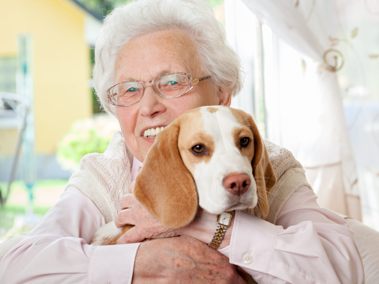 Elderly woman holding her dog