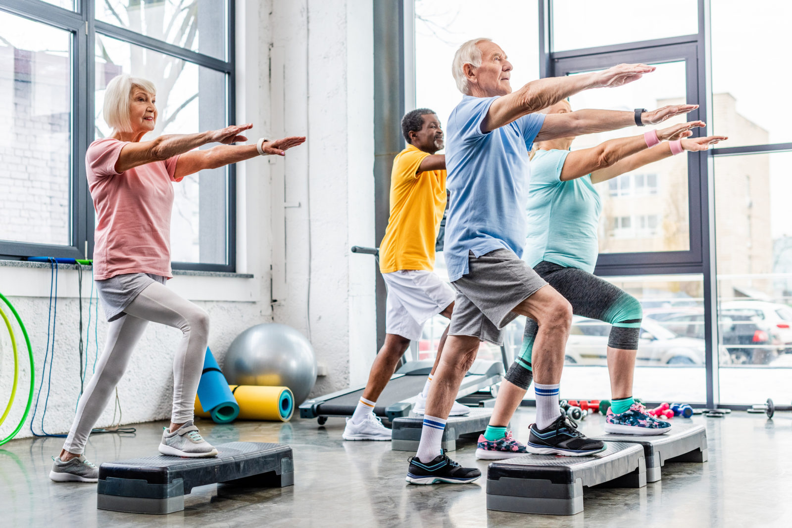 seniors participating in exercise class at a gym
