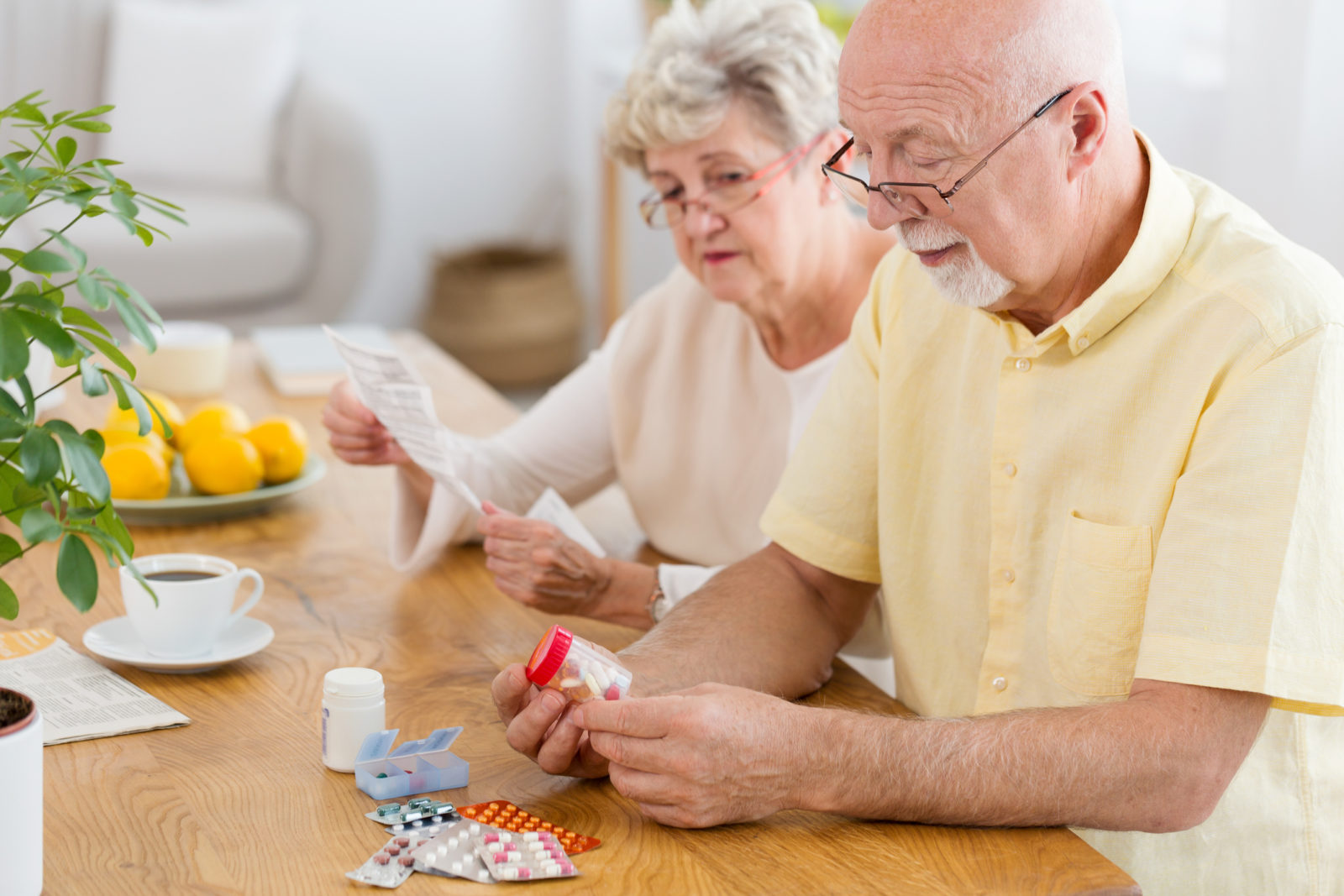 senior couple trying to figure out how to manage a multitude of drugs