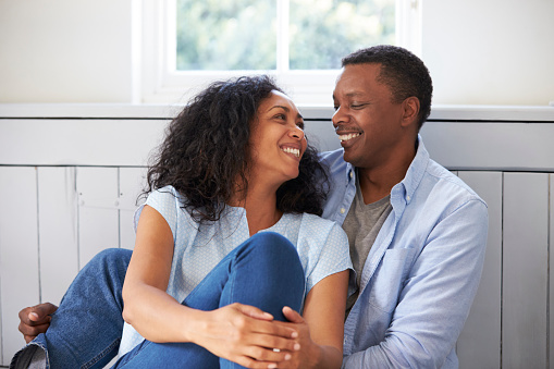 Romantic Couple Relaxing In Chair At Home