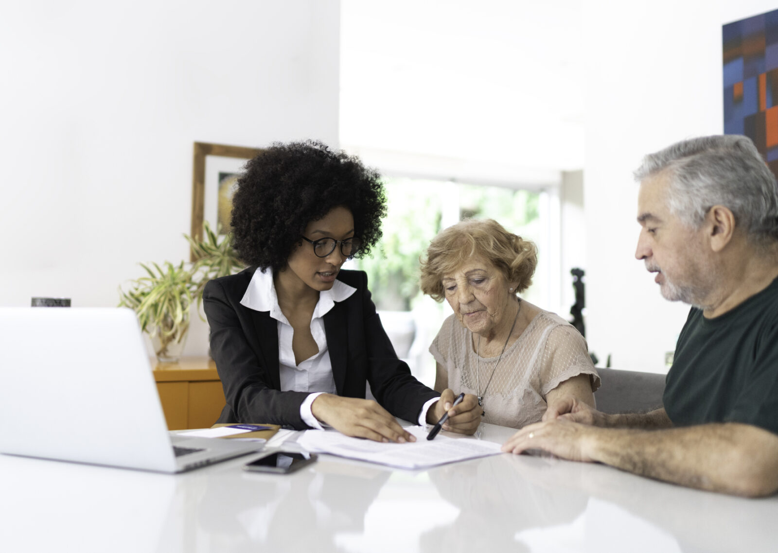Financial advisor helping a senior couple at home