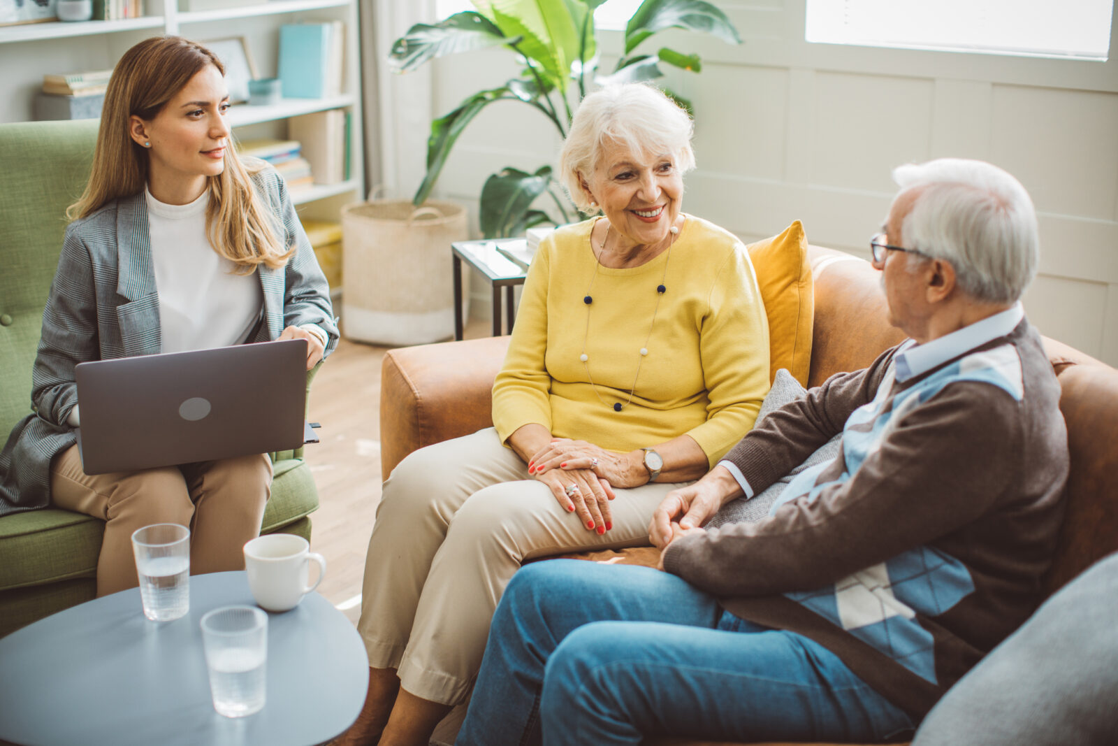 Senior couple consulting with female advisor