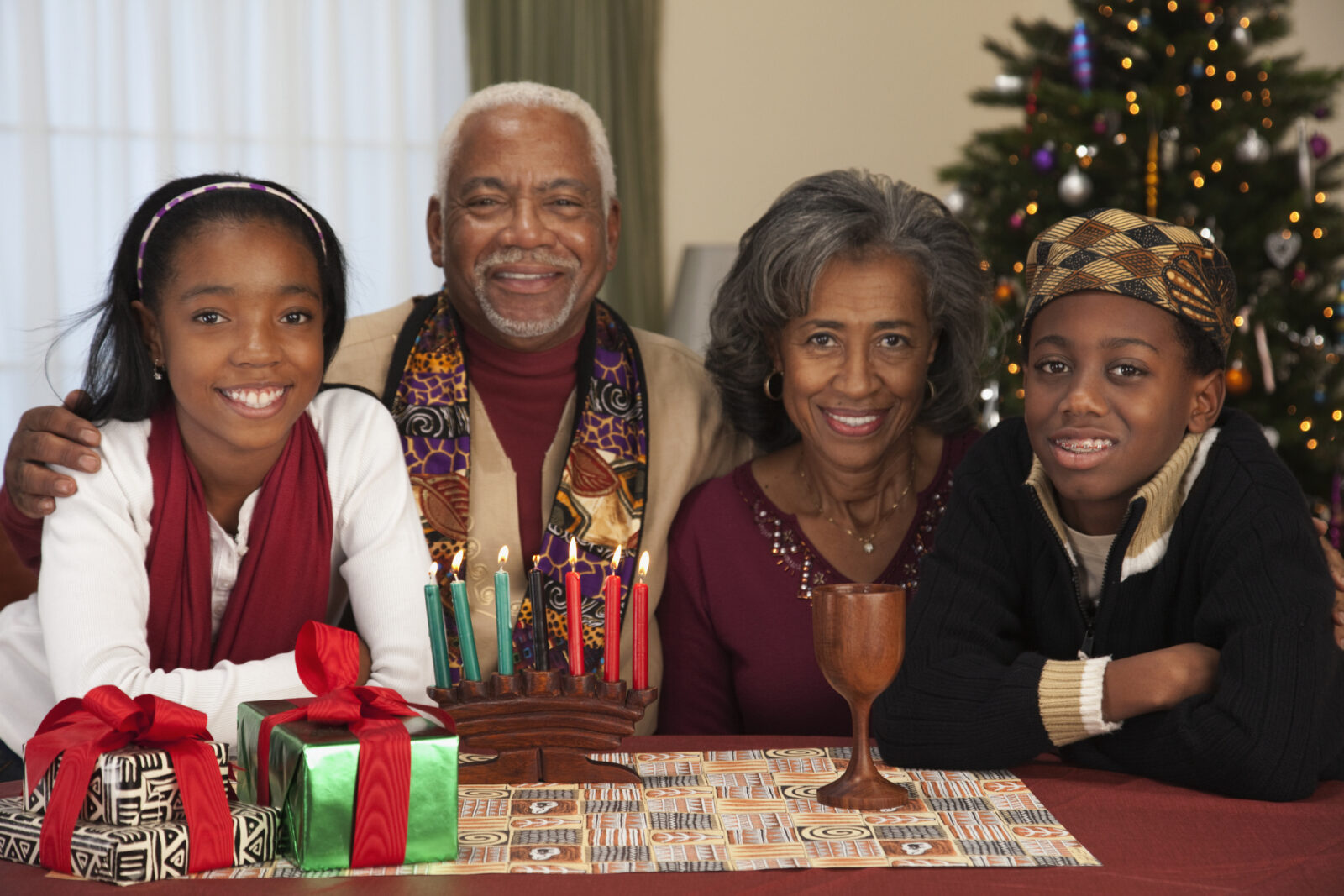 African-American couple with grandchildren celebrating Kwanzaa